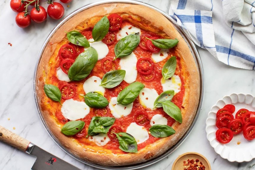 a freshly made pizza served at Village Takeaway in Glenboig