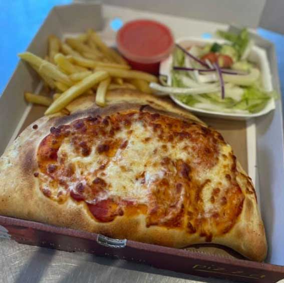 Loaded calzones with chips, salad and sauce served at Village Takeaway in Glenboig